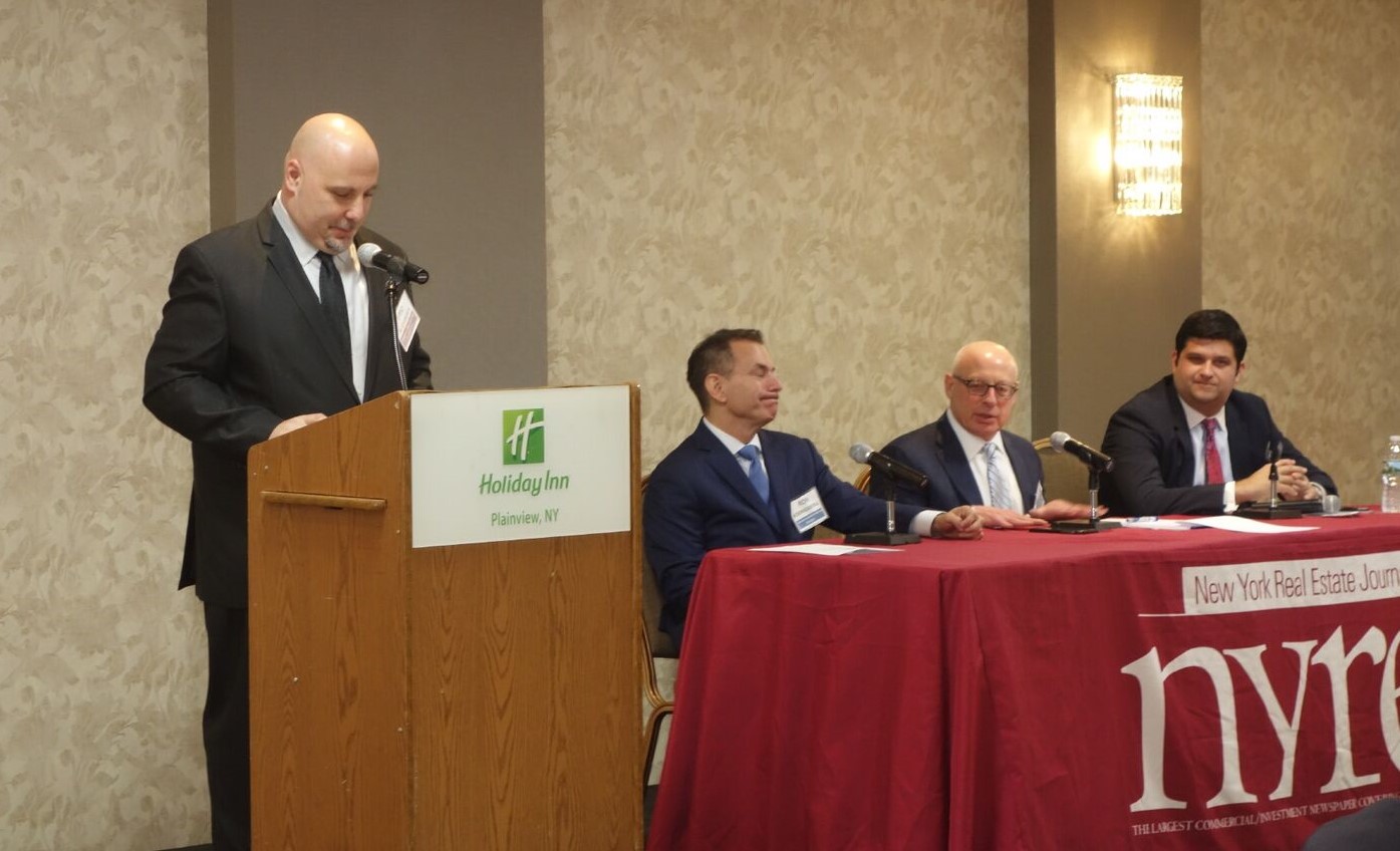 Michael H. Sahn (seated, center), the Firm’s Managing Partner, speaks at the 2018 'Future of Long Island Commercial Real Estate' summit